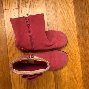 Cute pink boots with a flower on the side.